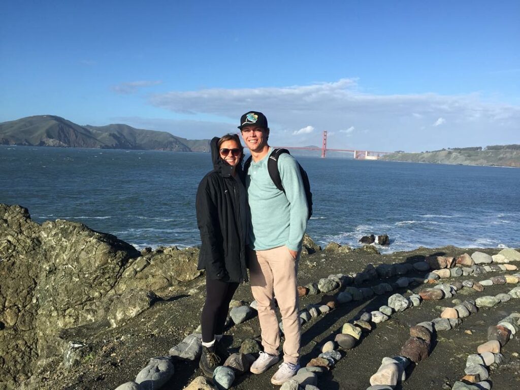 Nico and Julio standing on rocks near the golden gate bridge.